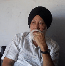 Saroop Singh, founder of Saroop Singh & Sons, seated in his office.
